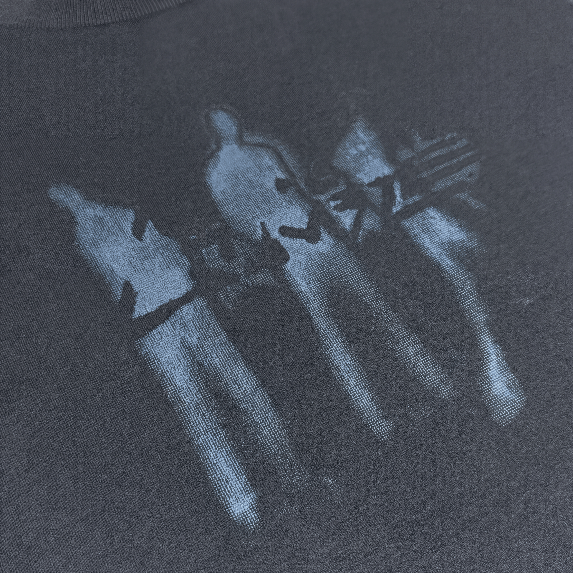 Black AVALIN tee from angled view, front graphic and distress texture subtly visible.